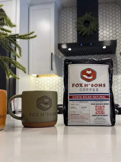 Fox N' Sons Coffee — a bag of Costa Rican Natural whole bean beside a branded stoneware mug